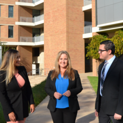 Career Counselor Laura Sosa with two students in front of the INTS building.