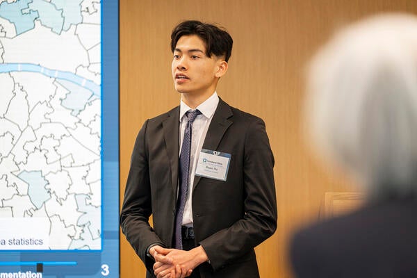 Alumni Bryan Ho giving a presentation.
