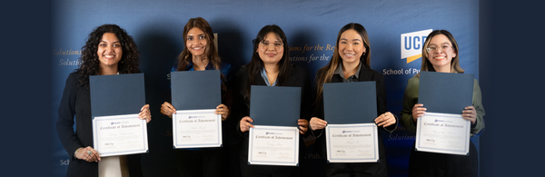 Five female students holding certifications for completing internships
