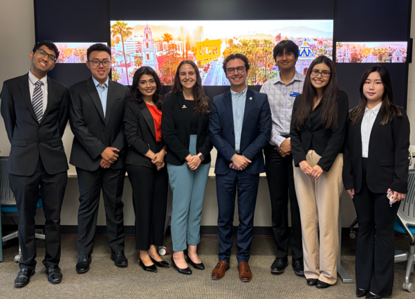 Group photo of students and Philip Falcone